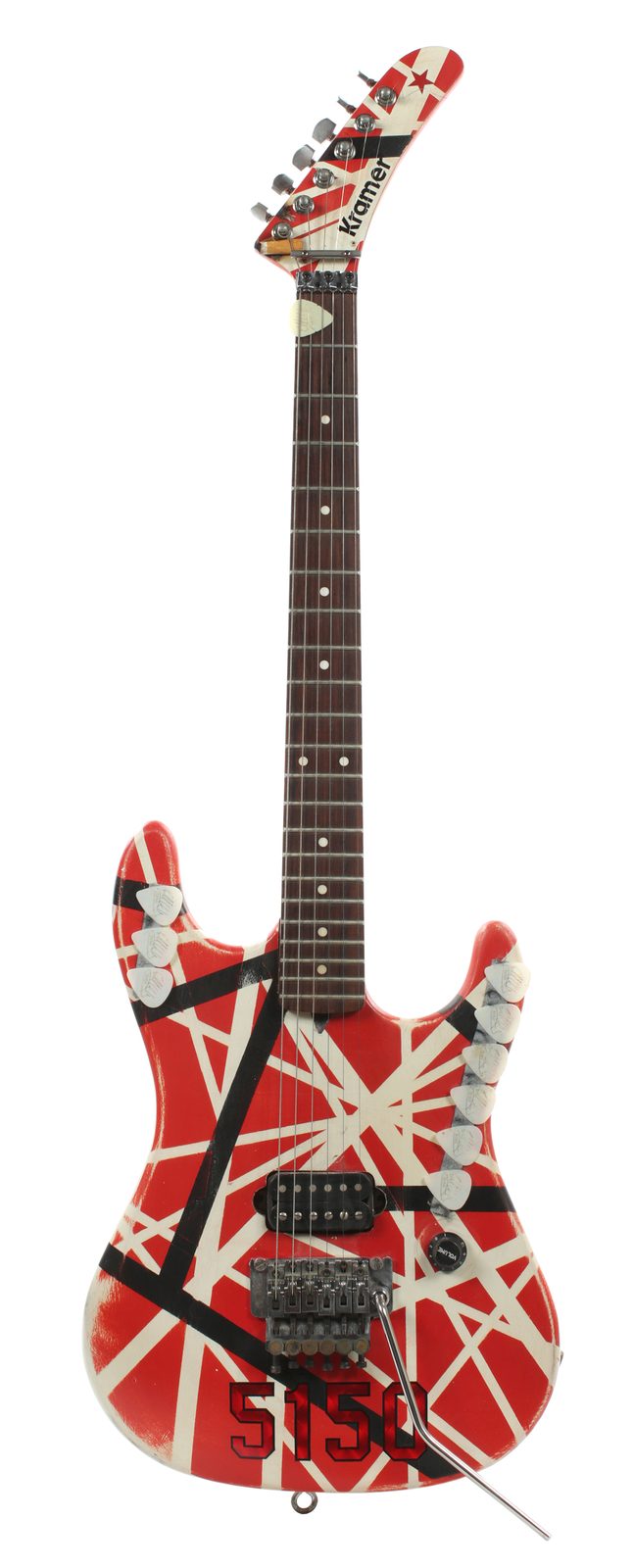 Full front view of the 1987 striped Kramer, with signed guitar picks tucked along both edges of the body