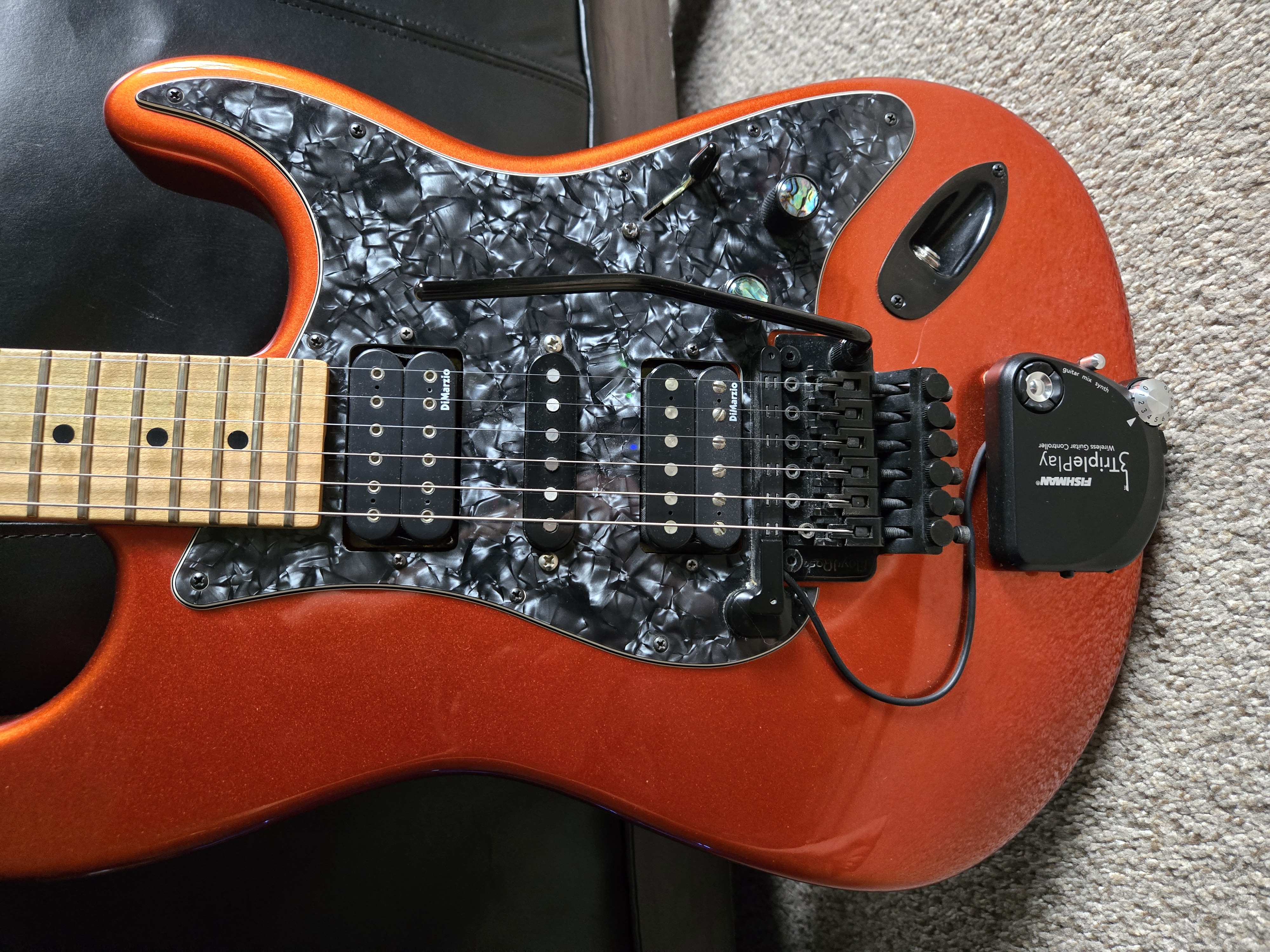 Close-up of the author's Charvel So-Cal: DiMarzio humbuckers, pearloid pickguard and a Floyd Rose tremolo