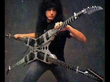 Michael Angelo Batio holding the four-neck Quad Guitar, two double-guitar sections crossed in an X